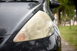 Dirty car headlights in need of headlight lenses restoration services.